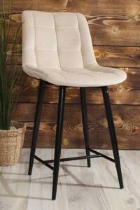 Eleganckie niskie krzesło barowe PROXI I pikowane z beżowego weluru na czarnych nogach